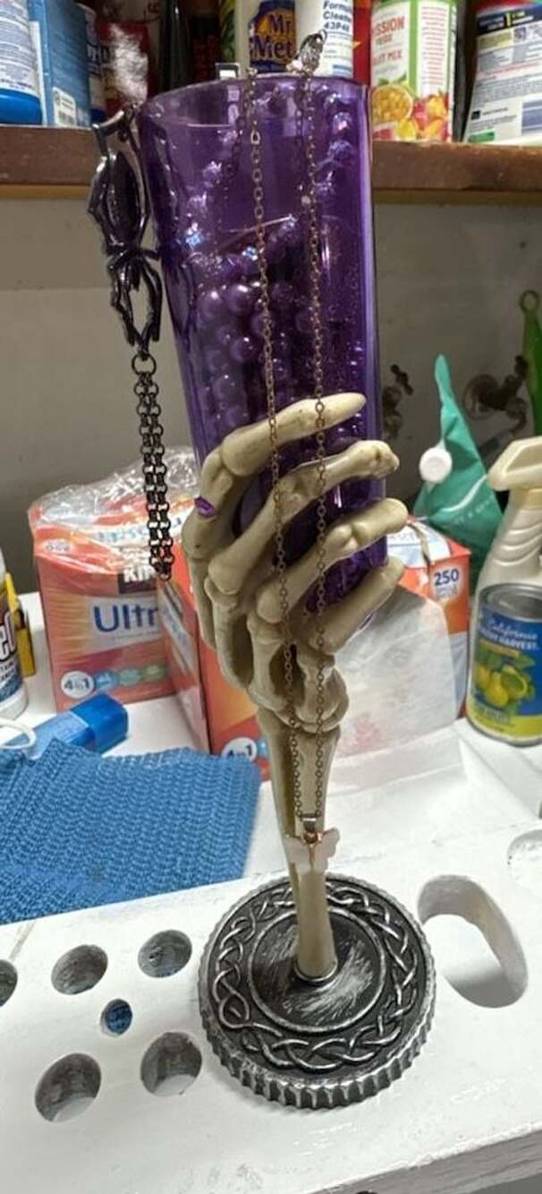 Halloween Skeleton Hand Purple Champagne Flute filled with jewelry all wearable